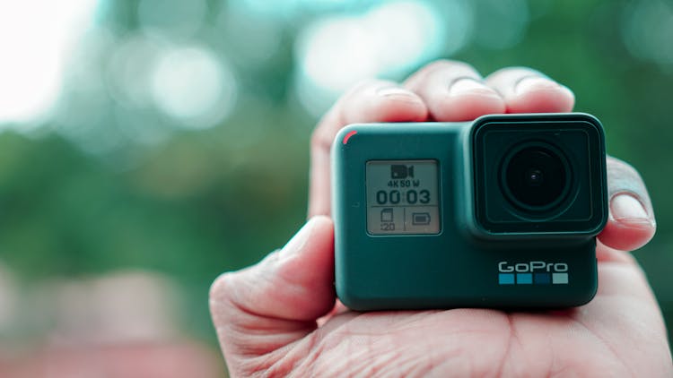 A Close-up Shot Of A Person Holding A GoPro Camera