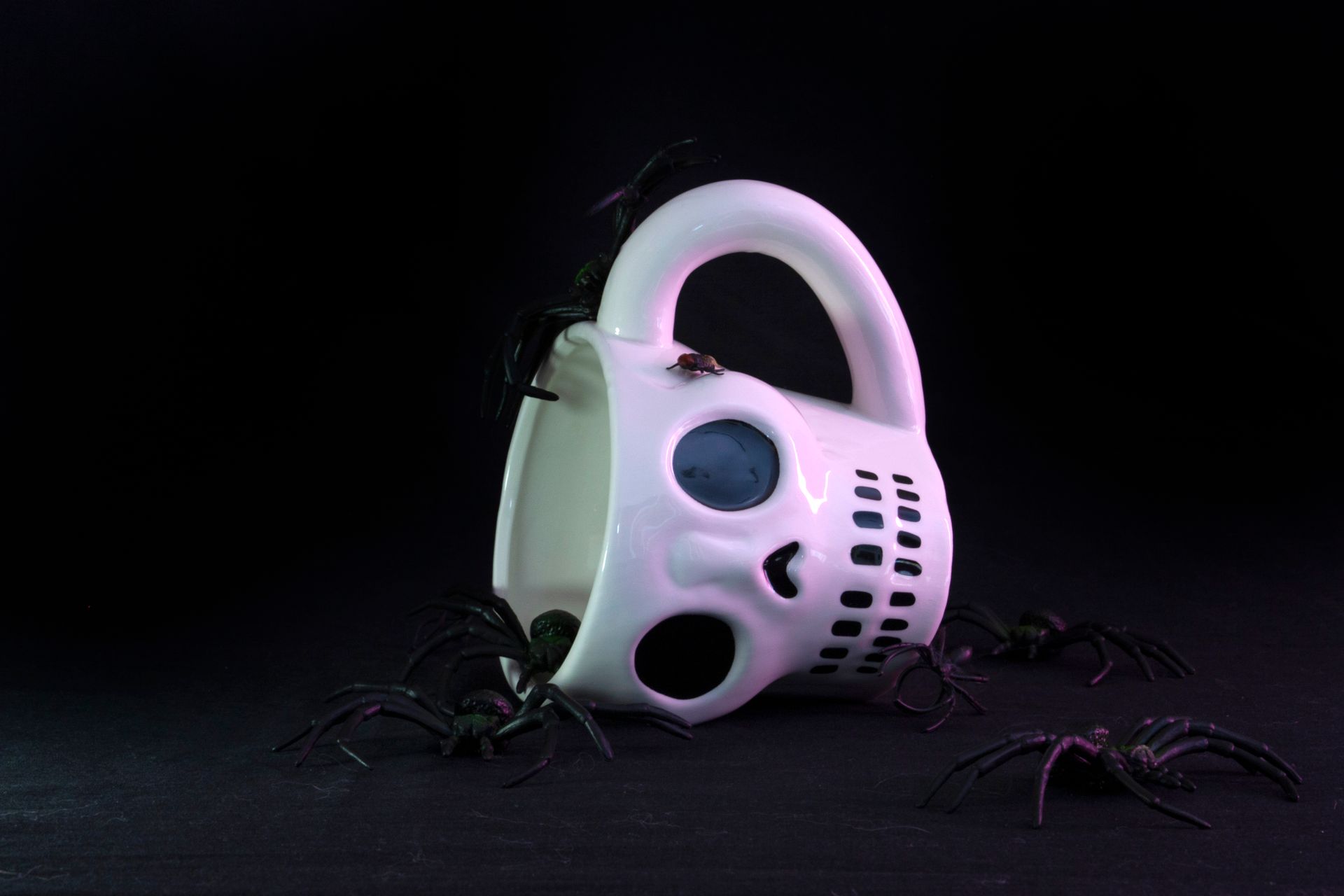 Close-up of a Mug in the Shape of a Skull and Fake Spiders