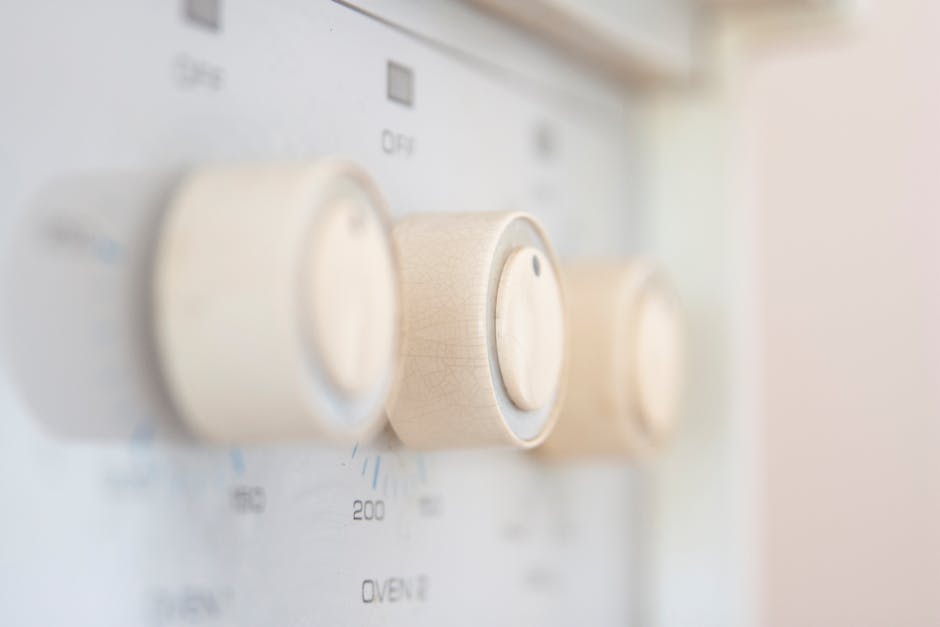 Artistic close-up of stove control knobs, highlighting design details in a kitchen setting.