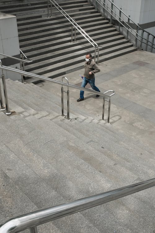 Man in Mask Walking near Stairs