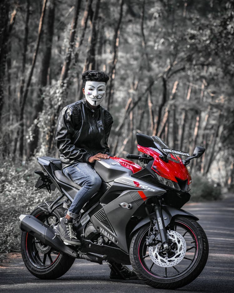 A Person With A Mask Sitting On A Motorcycle