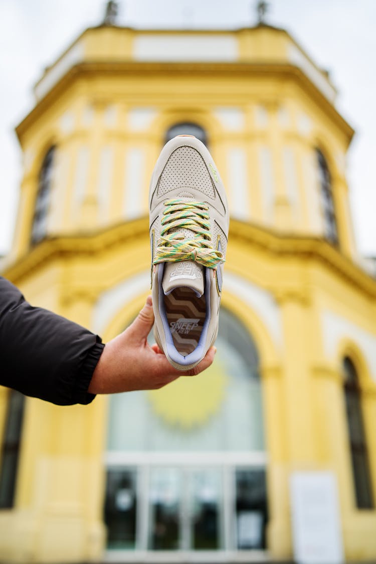 Person Holding A Sneaker 