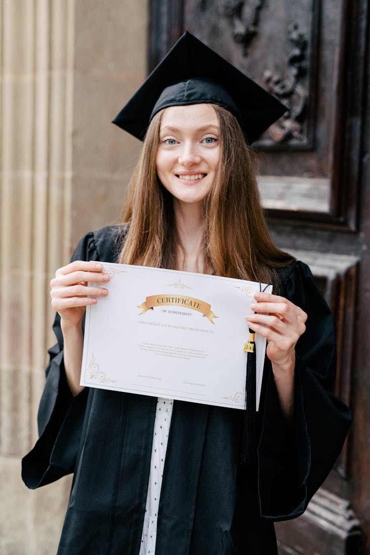 Newly Graduate Student Holding Her Graduation Certificate