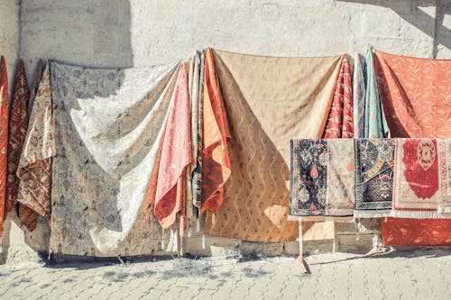 Blankets and Carpets Hanging Near a Wall