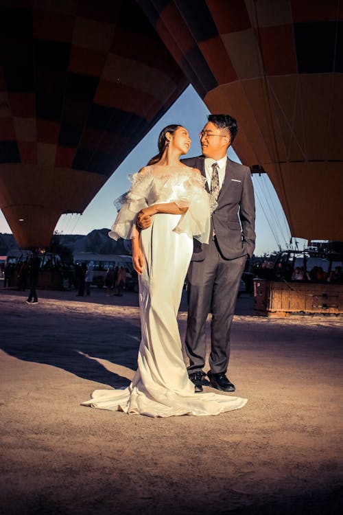 Couple Standing Near the Hot Air Balloons