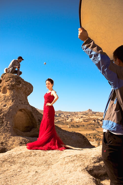 Woman in Red Gown Doing a Photoshoot