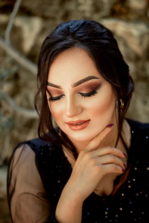 Free A captivating portrait of a woman with professional makeup, eyes closed, and a thoughtful expression. Stock Photo