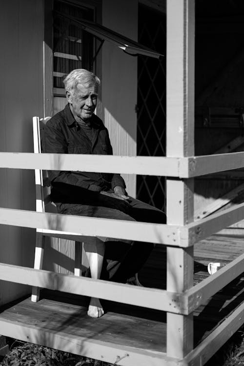 Free Grayscale Photo of an Elderly Man in the Balcony Stock Photo