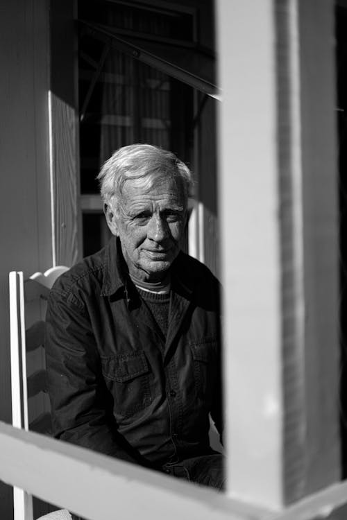 Man in Button Down Shirt Sitting on a Chair