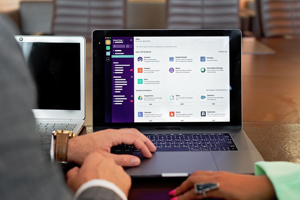 Business software comparison shown on multiple screens in office