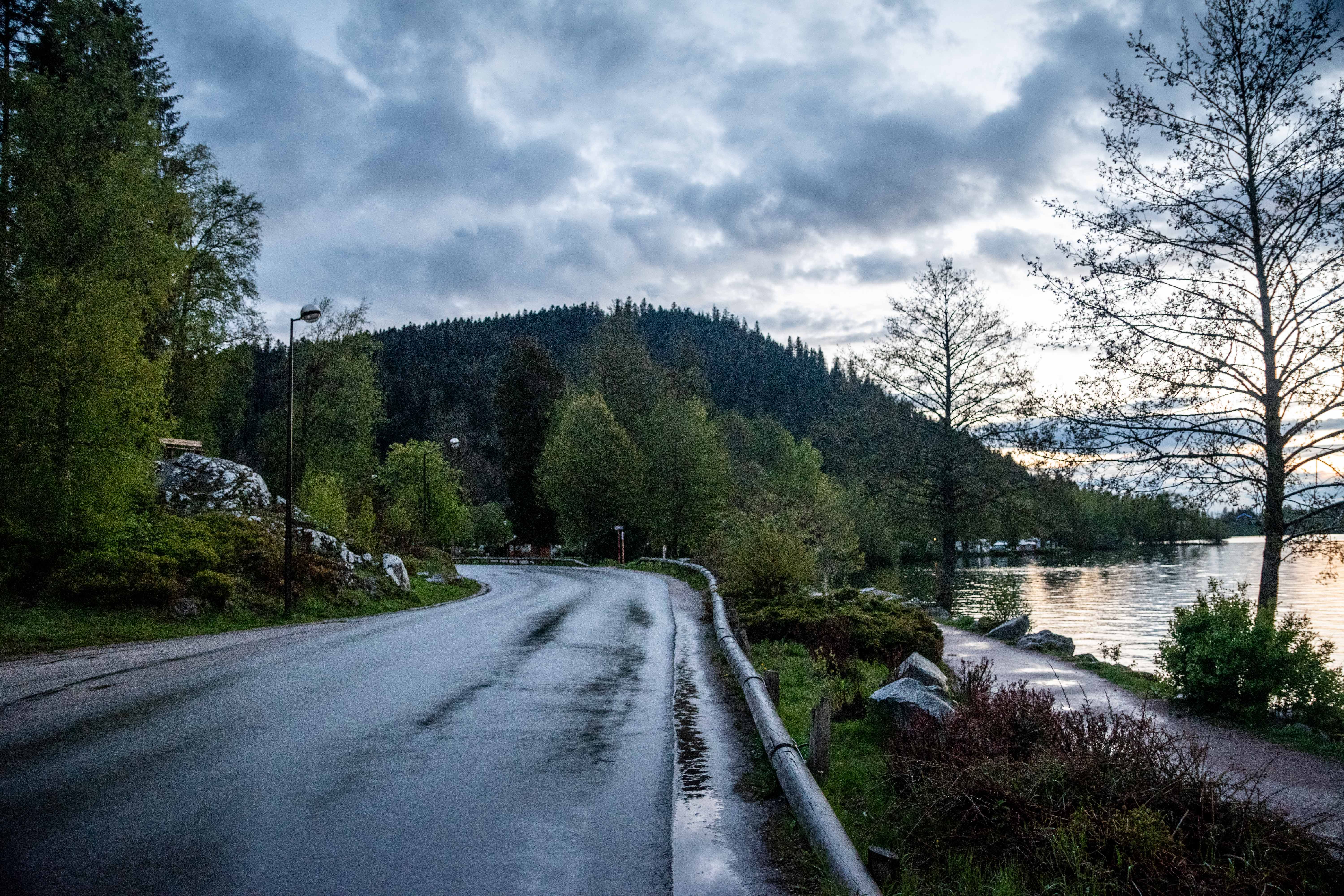 A quiet road under an overcast dusk sky