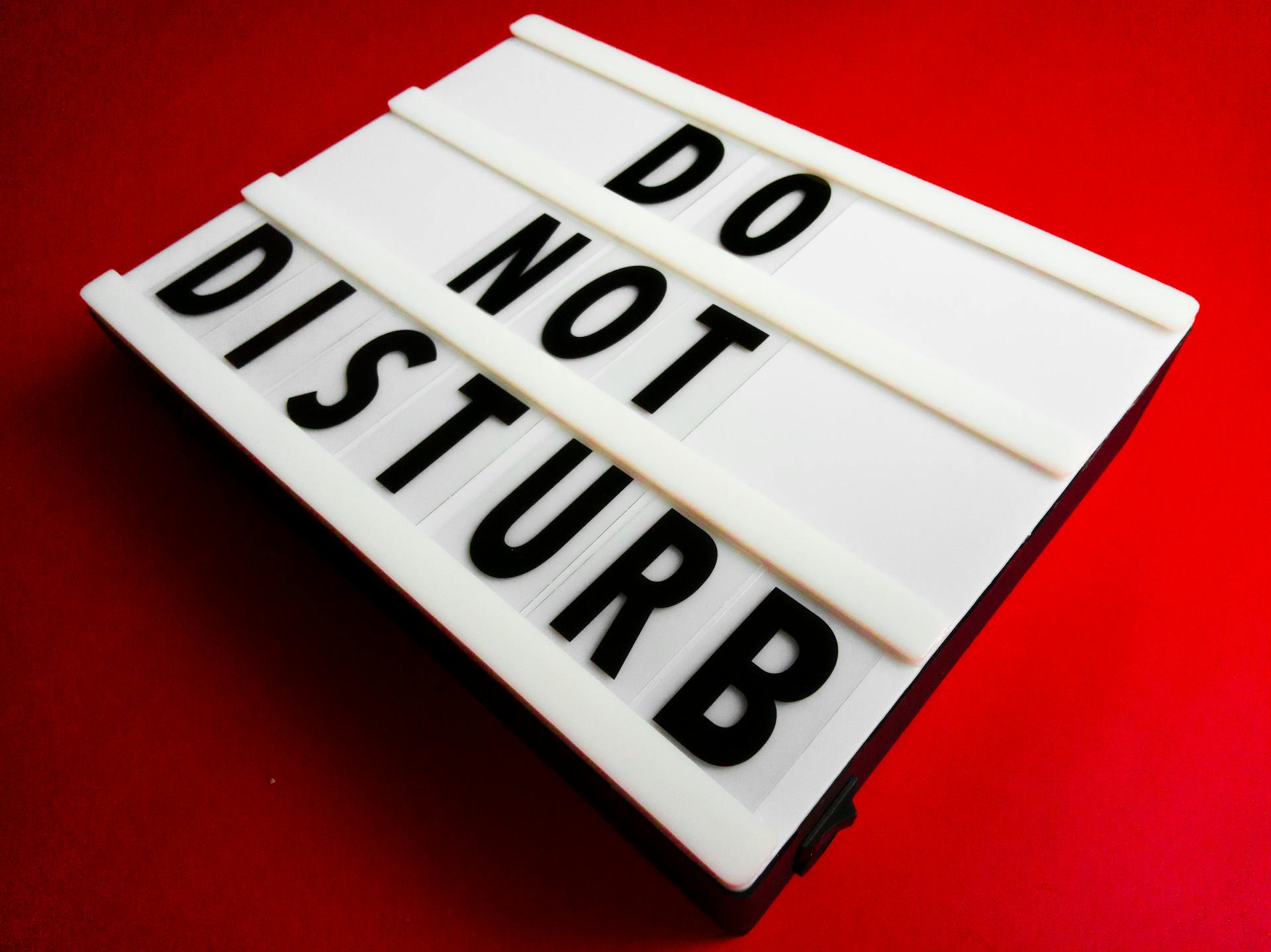 A Close-up Shot of a Do Not Disturb Sign on a Letter Board