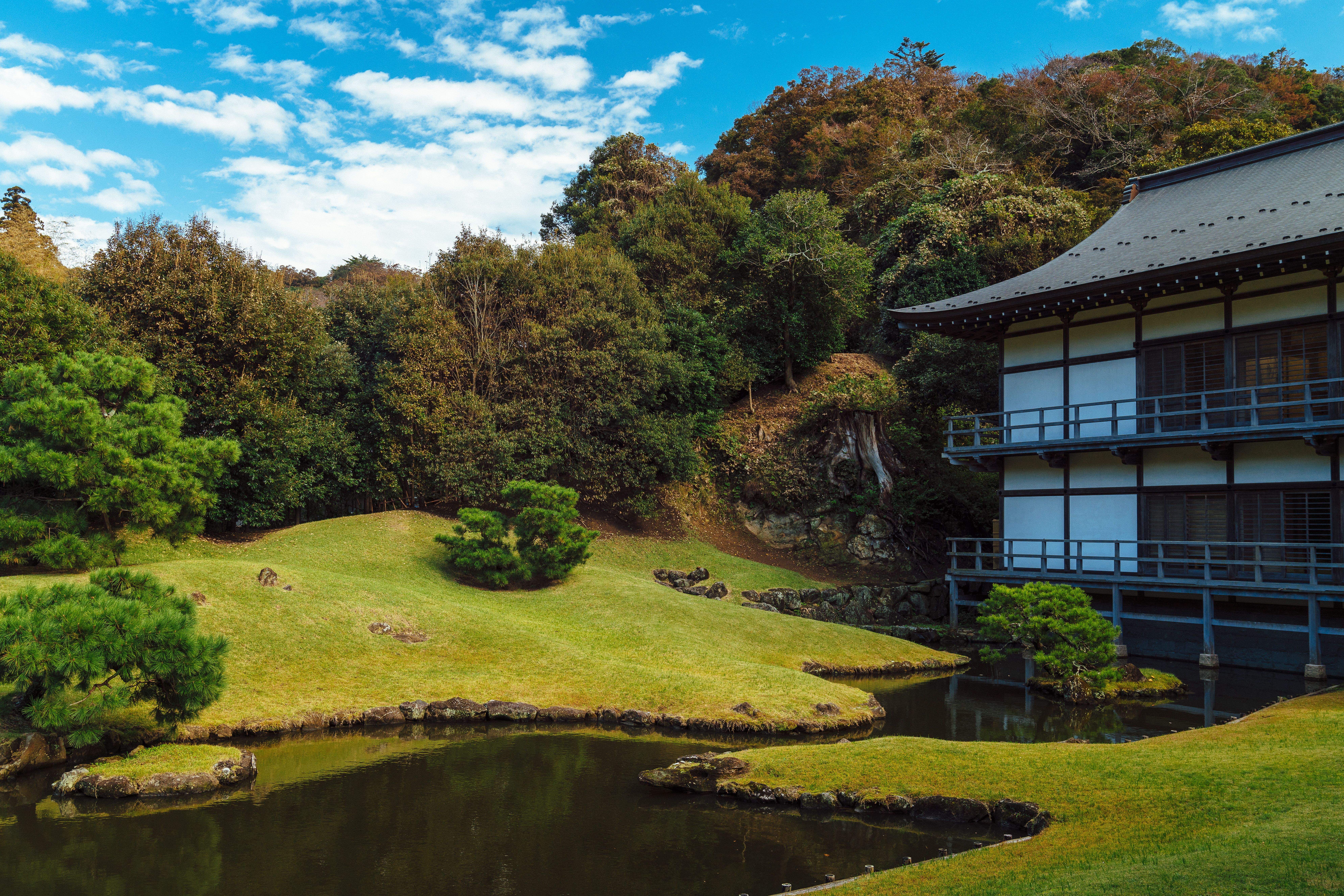 Traditional Japanese garden with pond and foliage in Kamakura, Japan.