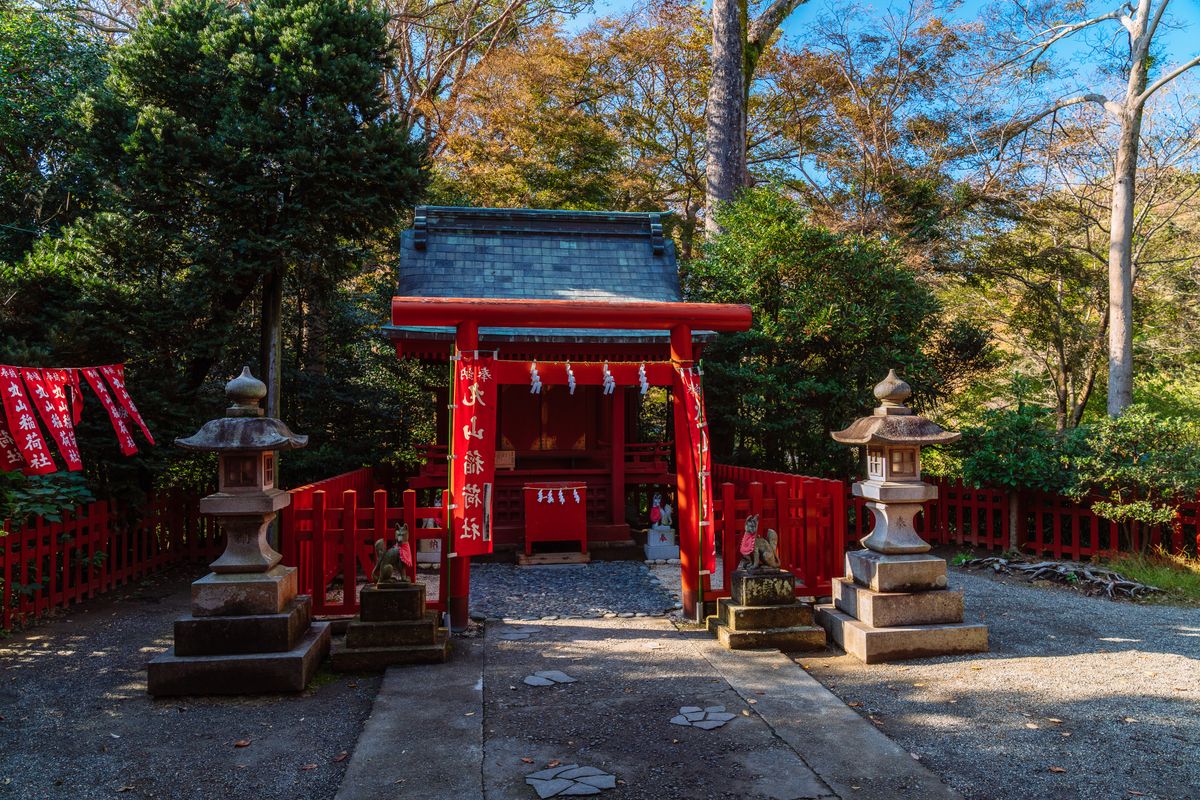 Japanese shrine lanterns and traditional wooden architecture illuminated at a Shinto sanctuary in Japan