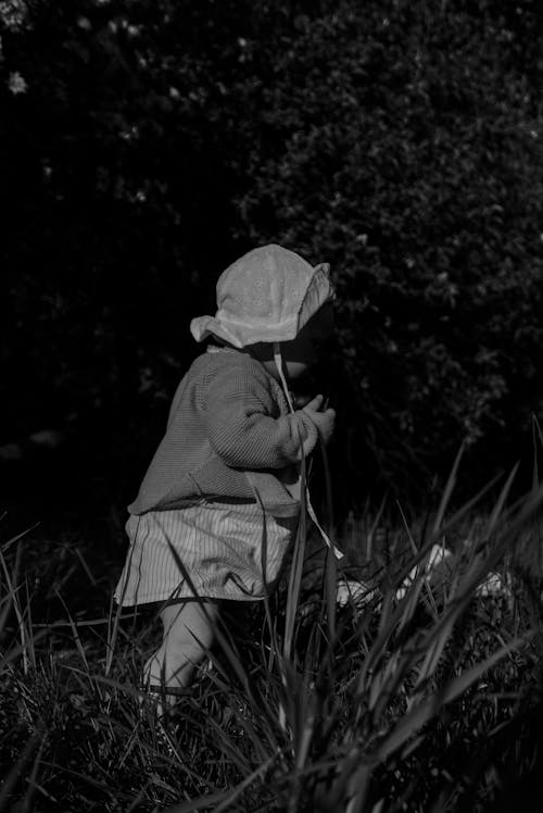 Free Monochrome Photo of Child on Grass Stock Photo