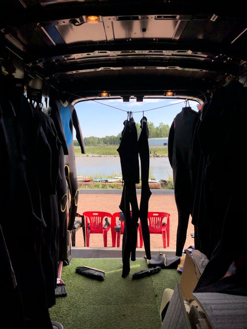 Free Wetsuits Hanging inside the Van Stock Photo