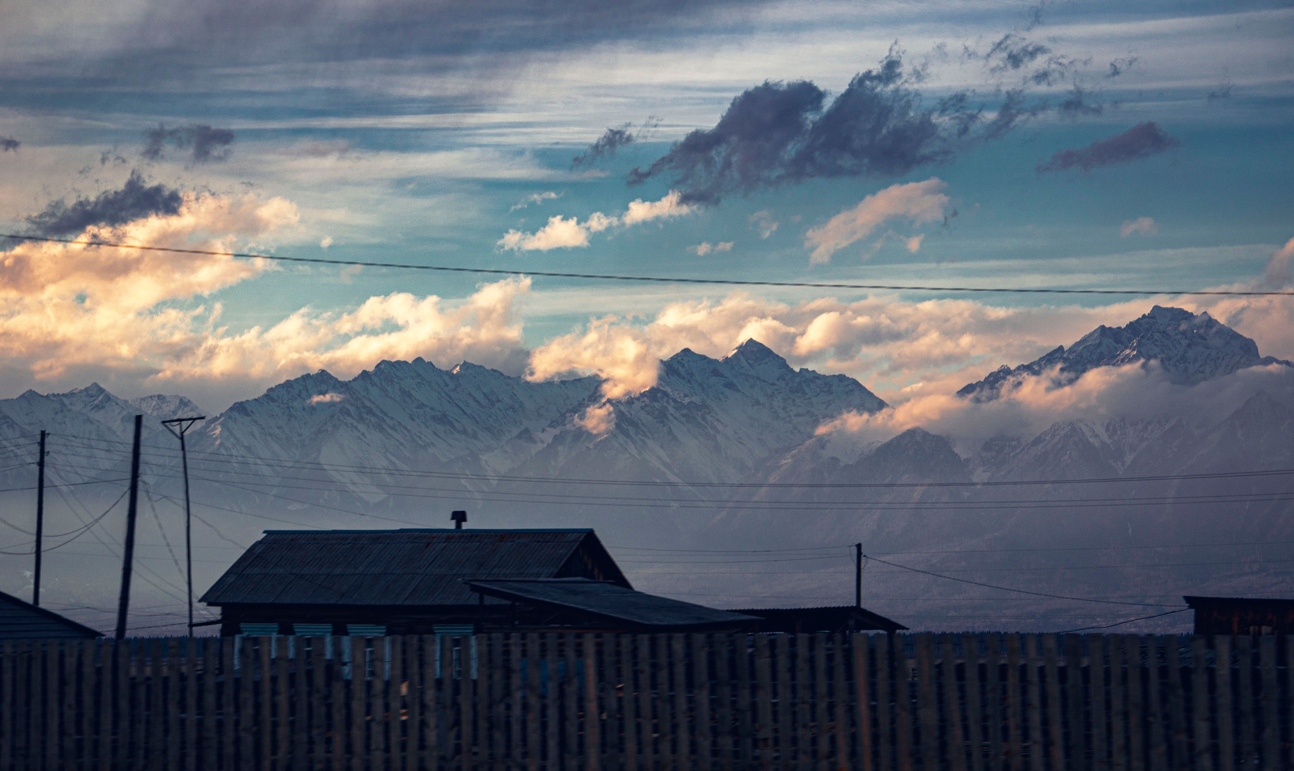 A House Near Snow Covered Mountains · Free Stock Photo