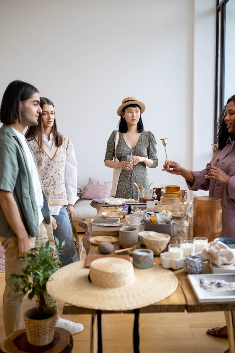 Group Of People In Front Of Objects On Top Of Table 