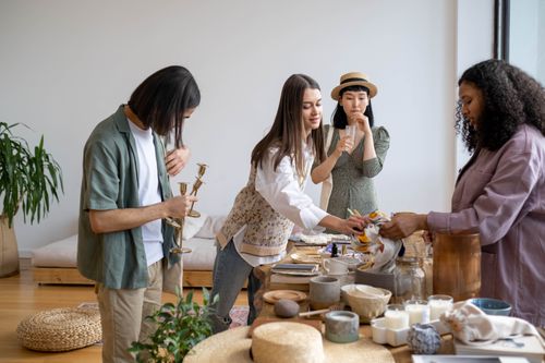 Free A multicultural group of adults enjoying a cozy indoor gathering with food and decor. Stock Photo
