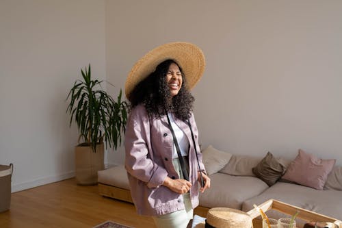 Photo of a Woman with a Straw Hat Laughing
