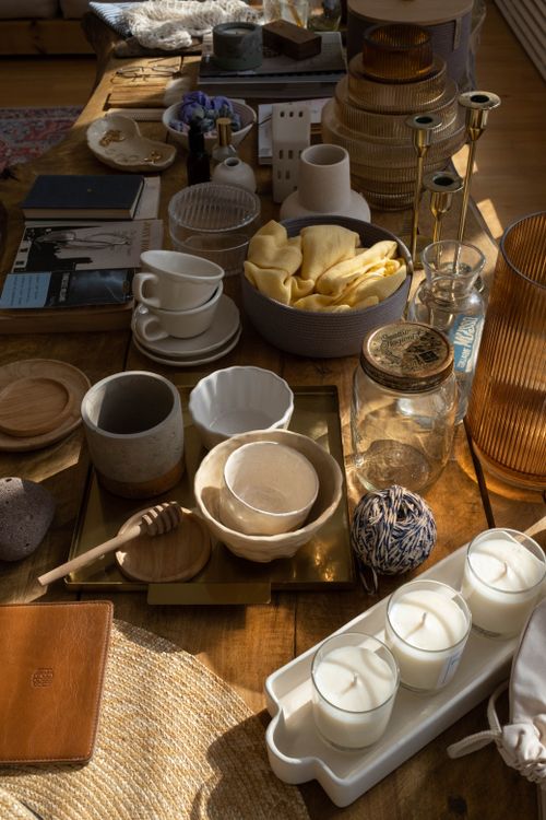 Free An inviting tabletop setting featuring assorted ceramics, decor pieces, and candles. Stock Photo