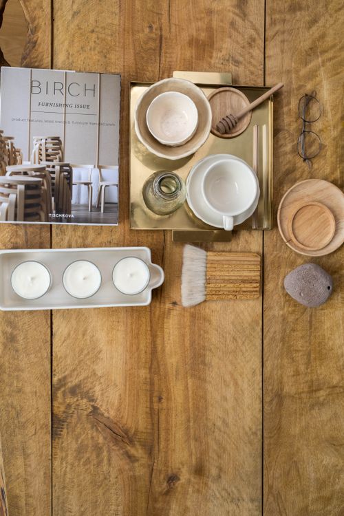 Free A stylish flat lay of home decor objects on a natural wood surface. Stock Photo