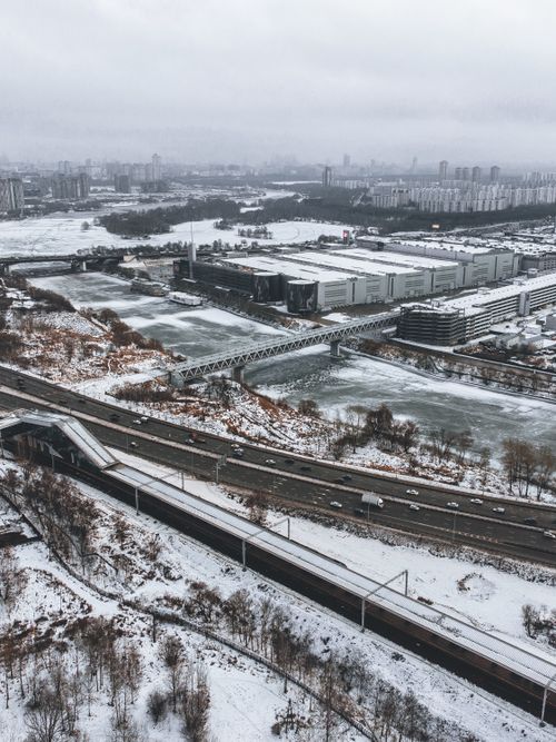 Free A bustling urban scene captured from above, showcasing snowy roads and buildings on a winter day. Stock Photo