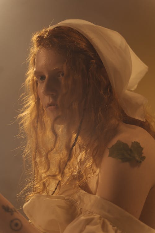 Woman in White Dress With Brown Curly Hair