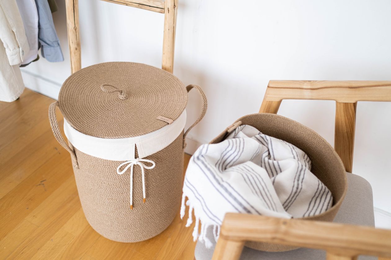 Woven laundry basket with folded linen