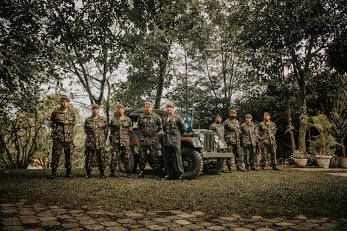 Free Group of Army Standing Near the Jeep  Stock Photo