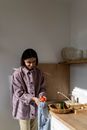 Woman in Pink Jacket Holding White Ceramic Mug