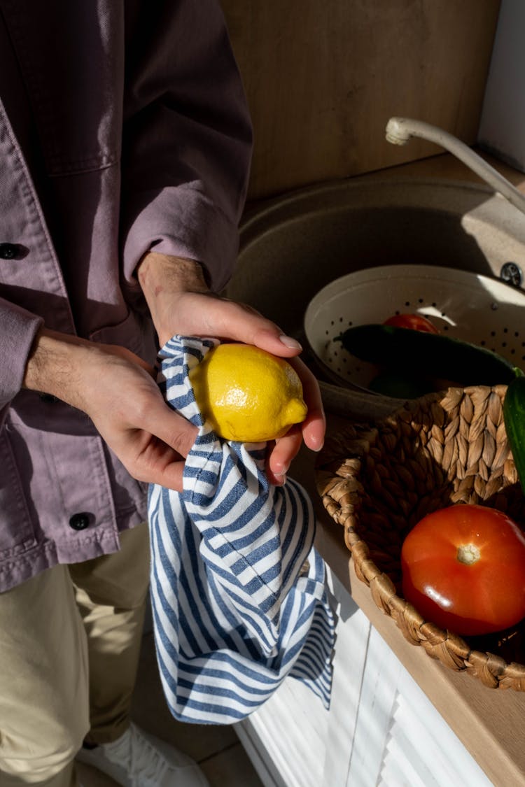 Person Cleaning The Lemon 