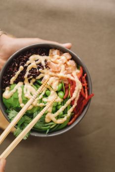 Vibrant poke bowl with fresh vegetables and salmon, perfect for healthy eating concepts.