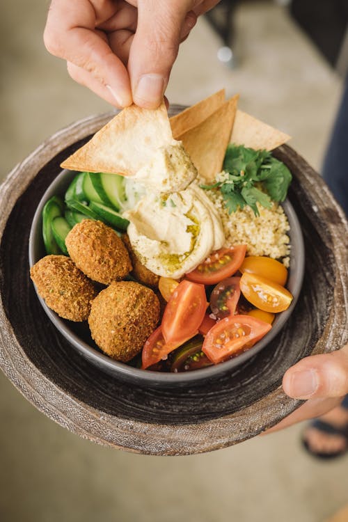 A Person Taking Food from a Bowl