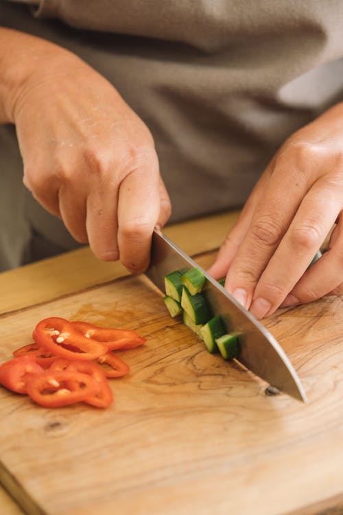 A Person Slicing Vegetables