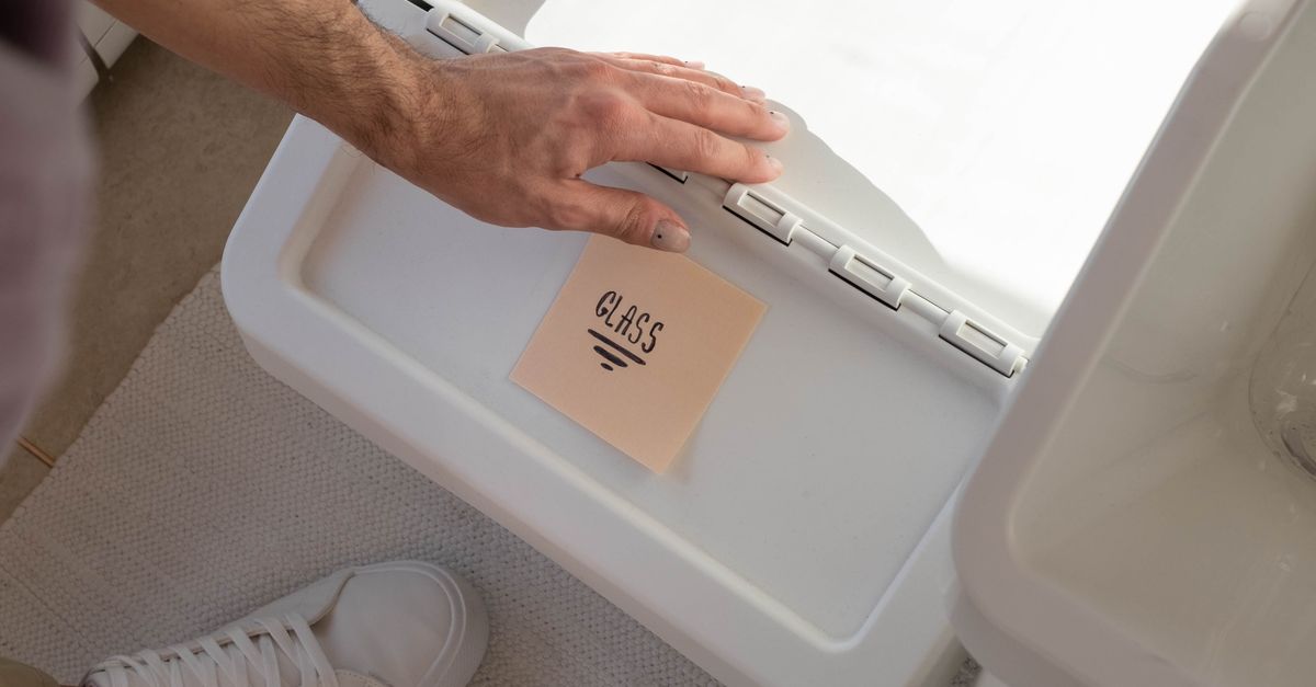 A Person Putting a Sticky Note on the White Trash Bin · Free Stock Photo