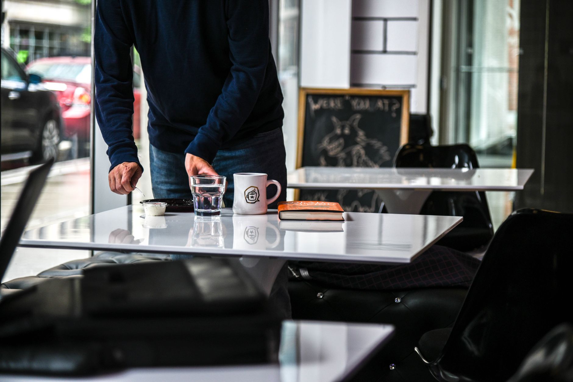 A creative workspace with a book, coffee and carefully arranged materials.
