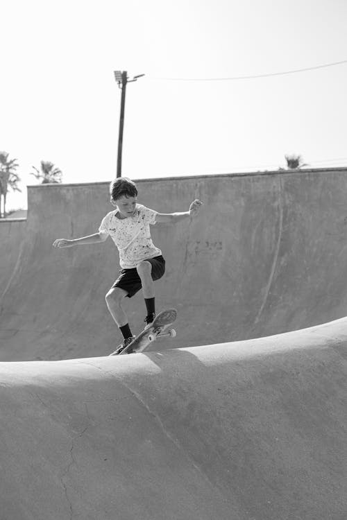 Monochrome Photo of a Boy Skateboarding 