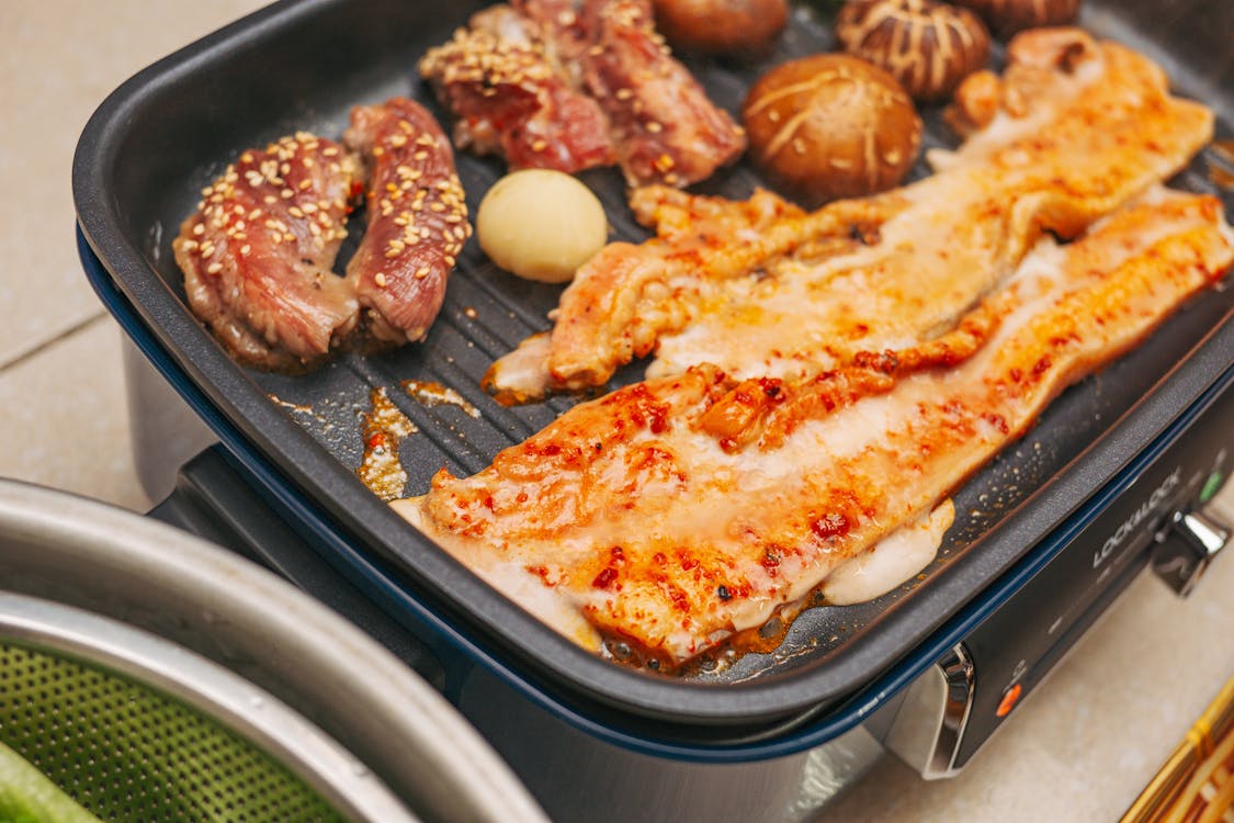 Free Cooking Korean Food on a Pan Grill Stock Photo