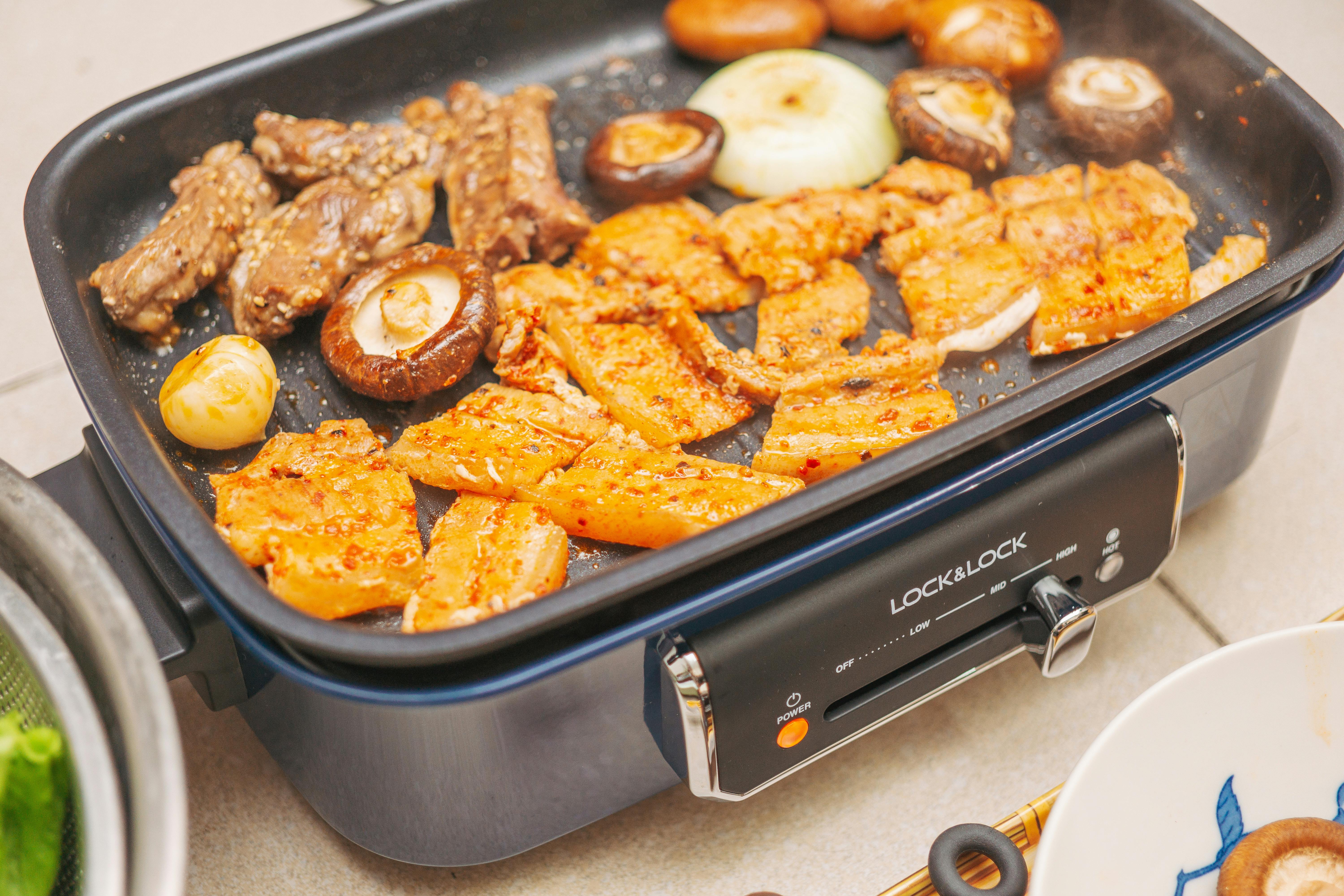 An enticing image of grilled meat and vegetables on a nonstick grill. Perfect for food enthusiasts.