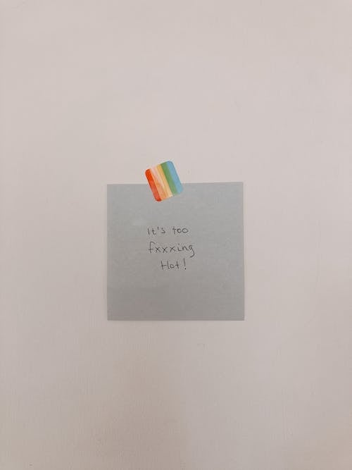 Free Note paper with text attached to wall with rainbow colored sticker Stock Photo