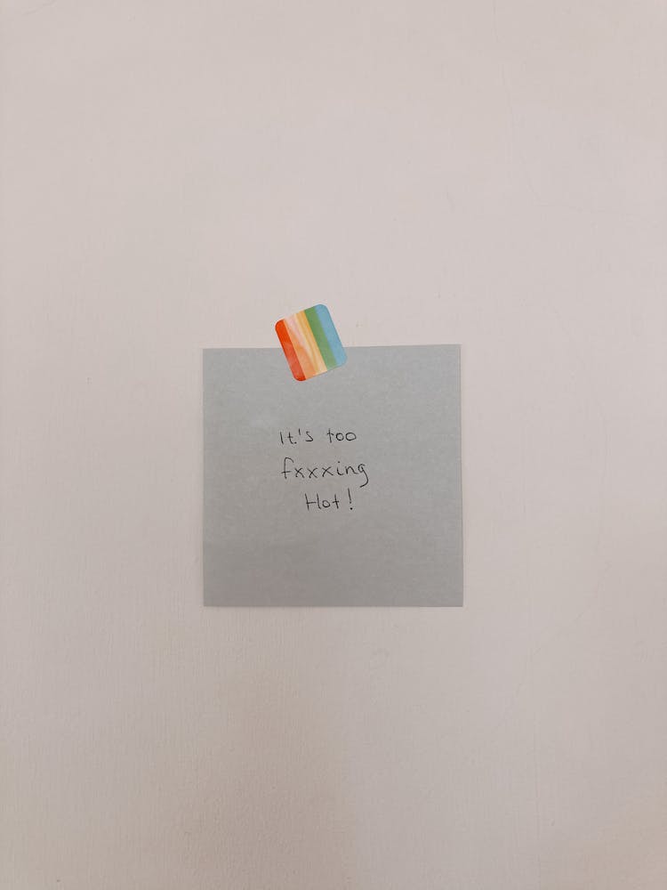 Note Paper With Text Attached To Wall With Rainbow Colored Sticker