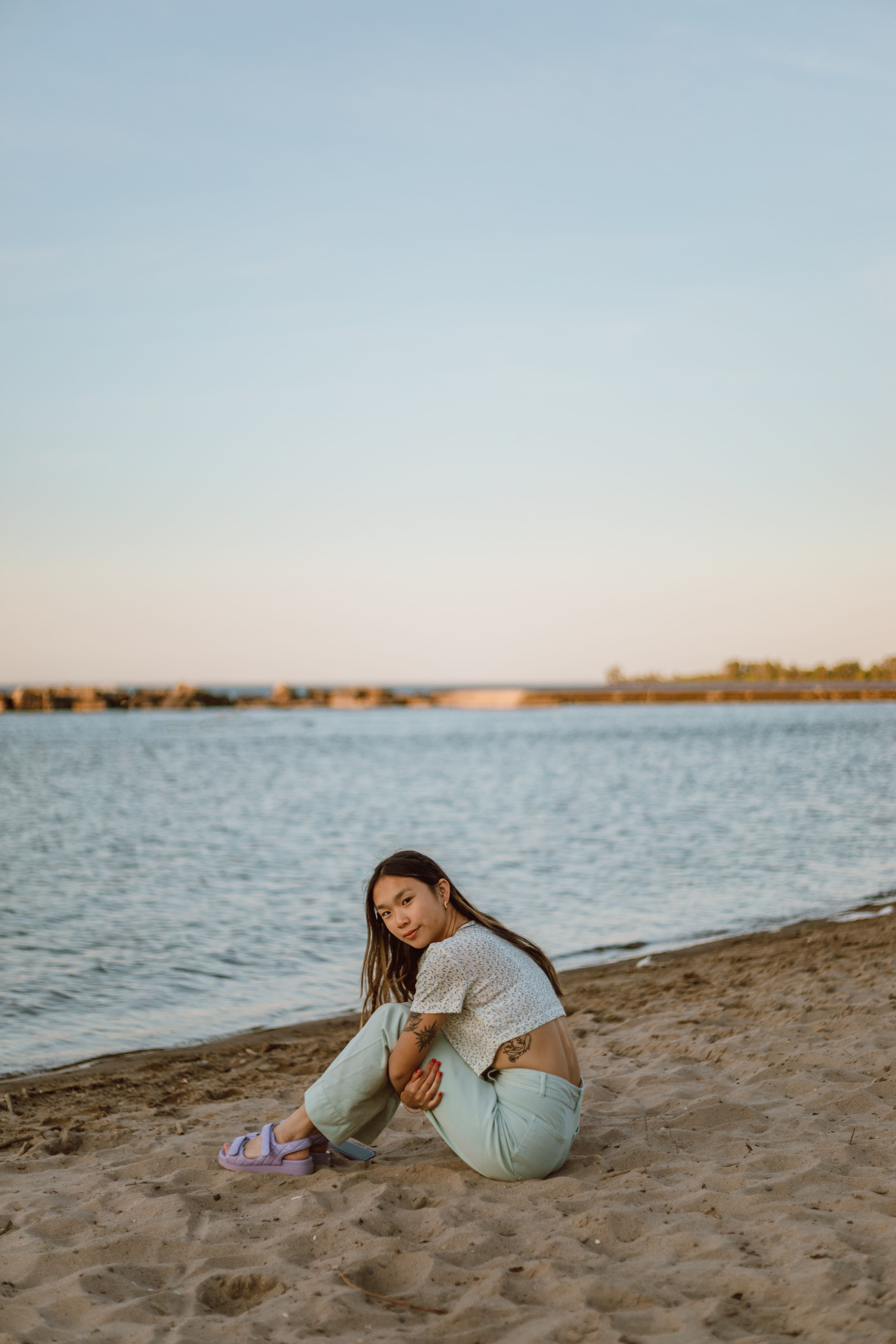 A Woman Sitting on the Beach · Free Stock Photo