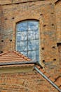 A Brown Brick Building with a Stained Glass Window