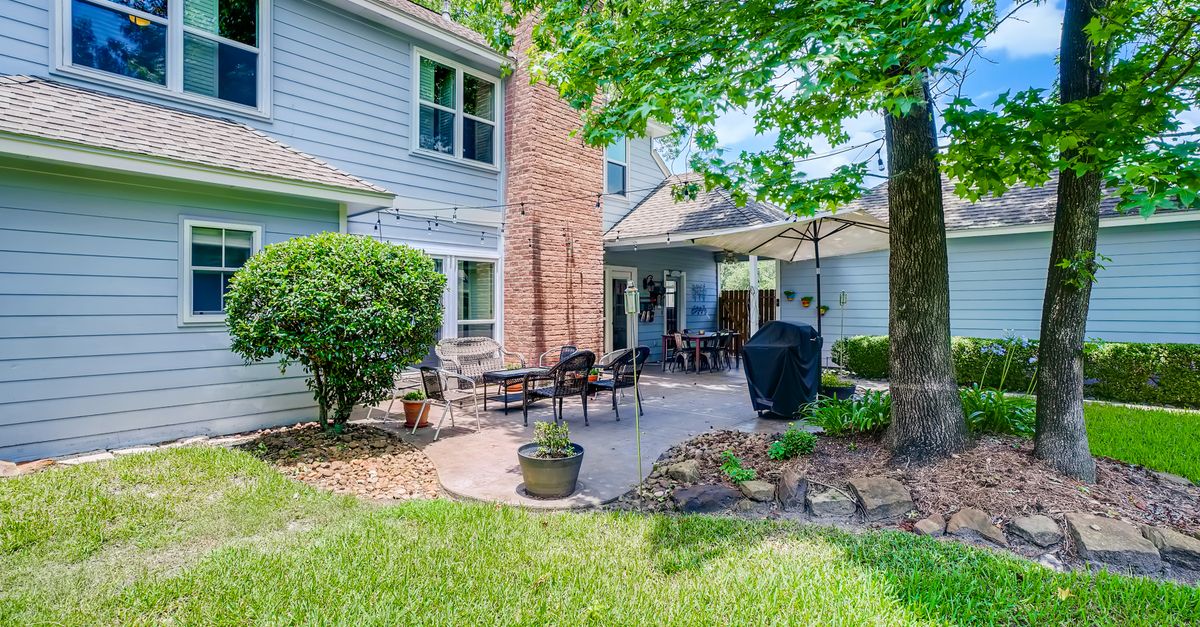 Beautiful residential backyard featuring a cozy patio and lush green surroundings.