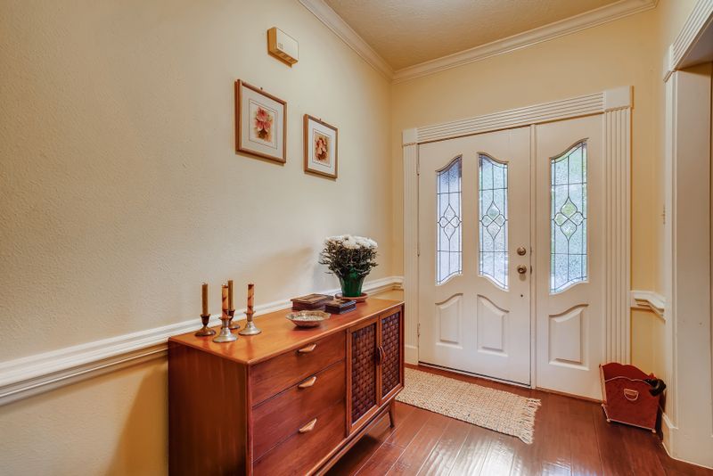 Stylish entryway featuring a wooden sideboard console with decor