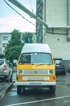 An iconic Volkswagen T3 Camper parked in a city lot, showcasing retro style.
