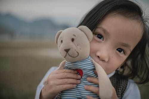 Free Child Holding a Plush Toy Stock Photo