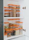 Clear Plastic Containers with Assorted Nuts and Grains on White Shelf