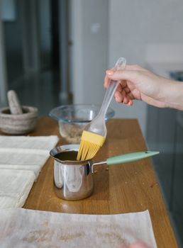 A Person Holding a Basting Brush
